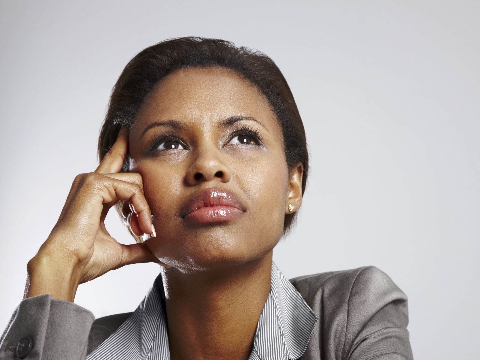 Young African American business woman looking away in a thought against a background