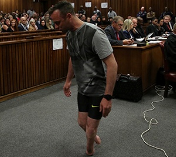 Oscar Pistorius, walks on his stumps during argument in mitigation of sentence by his defense attorney Barry Roux in the High Court in Pretoria, South Africa, Wednesday, June 15, 2016. An appeals court found Pistorius guilty of murder and not a lesser charge of culpable homicide for the shooting death of his girlfriend Reeva Steenkamp. (Siphiwe Sibeko, Pool Photo via AP)